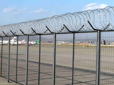 Galvanized welded wire mesh fence around the airport with razor barbed wire on the top.