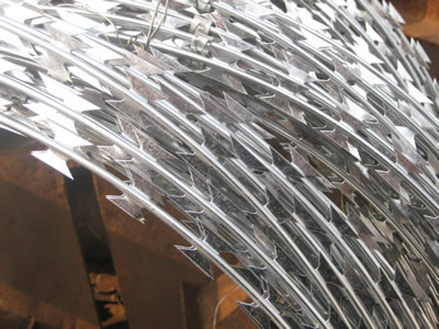 A coil of zinc coated concertina wires with galvanized clips.