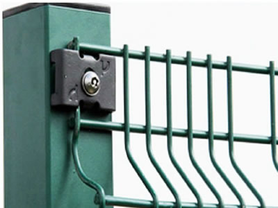 A green painted paladin fence panel fixed to square post with clips.