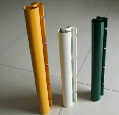 Three each posts in yellow, white and green colors on the ground