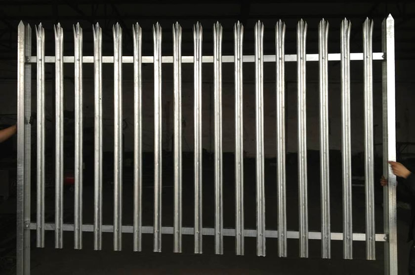 Two workers are holding the palisade fence.